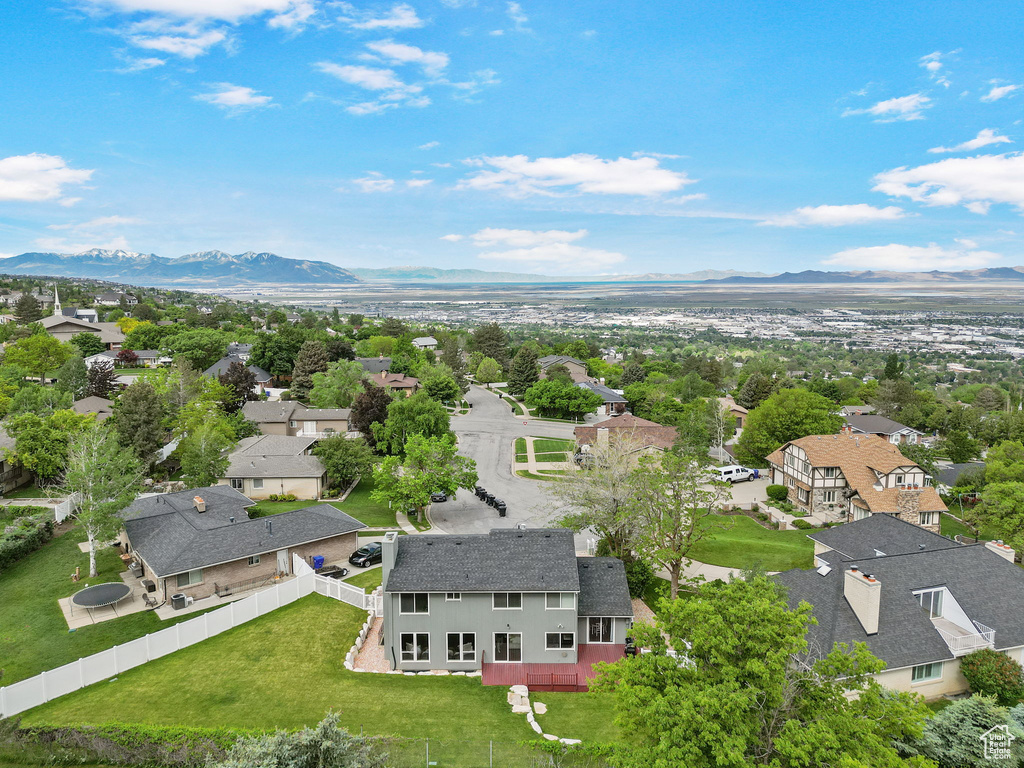 Aerial perspective of suburban area featuring a mountainous background