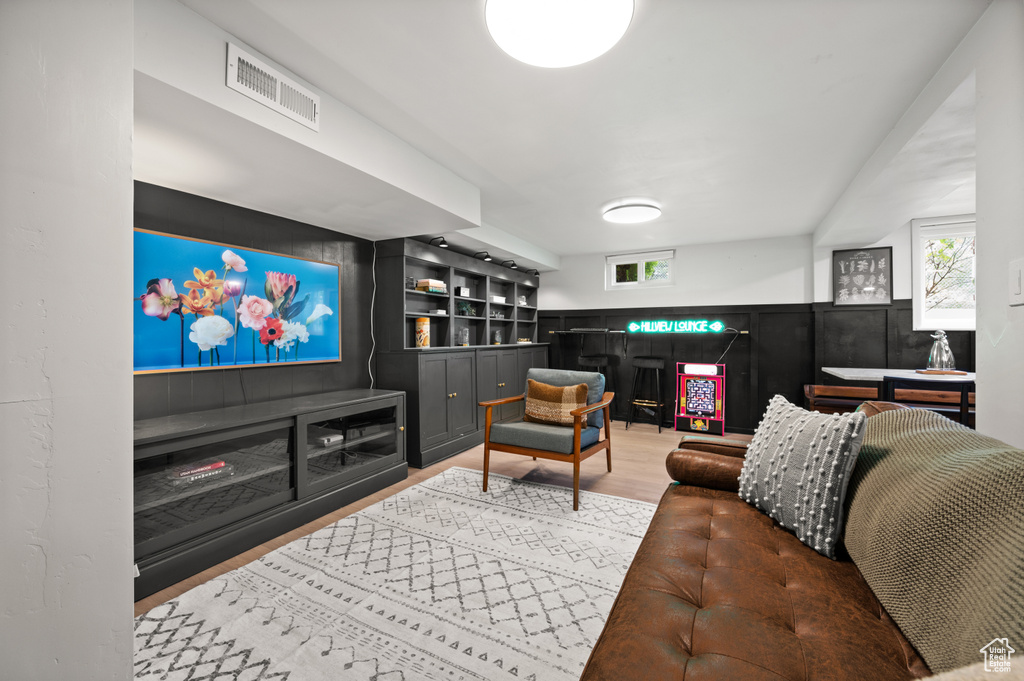 Living area with healthy amount of natural light and wood finished floors