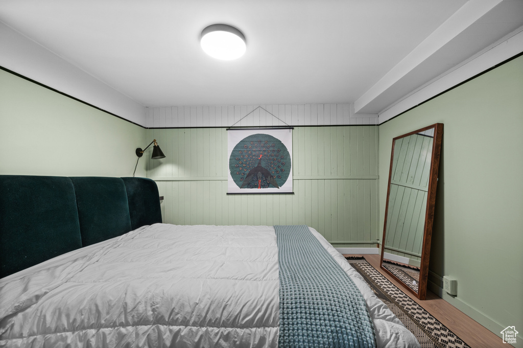 Bedroom featuring wood finished floors and baseboards