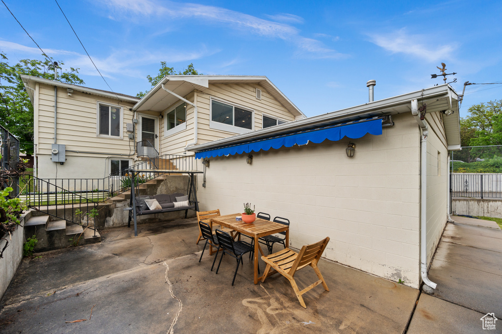 View of patio with fence and outdoor dining area