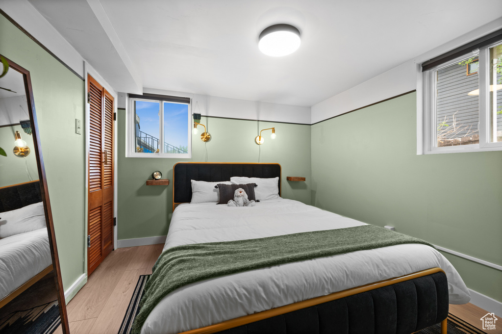 Bedroom with wood finished floors and baseboards
