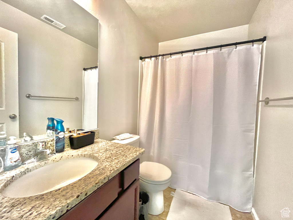 Bathroom featuring toilet and vanity