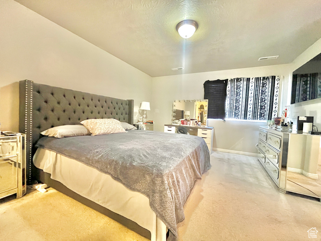 Bedroom featuring light colored carpet and baseboards
