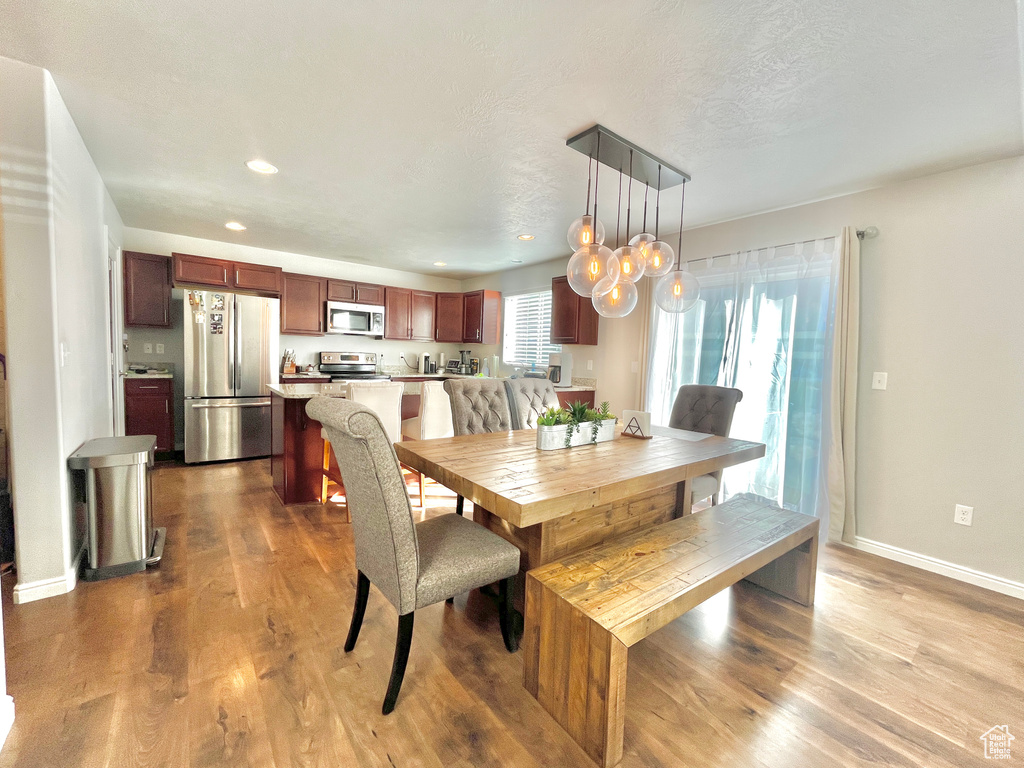 Dining area featuring dark wood-style floors, recessed lighting, and baseboards