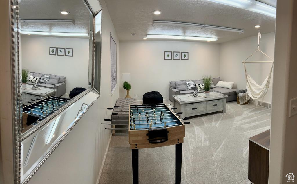 Game room with carpet floors, baseboards, recessed lighting, and a textured ceiling