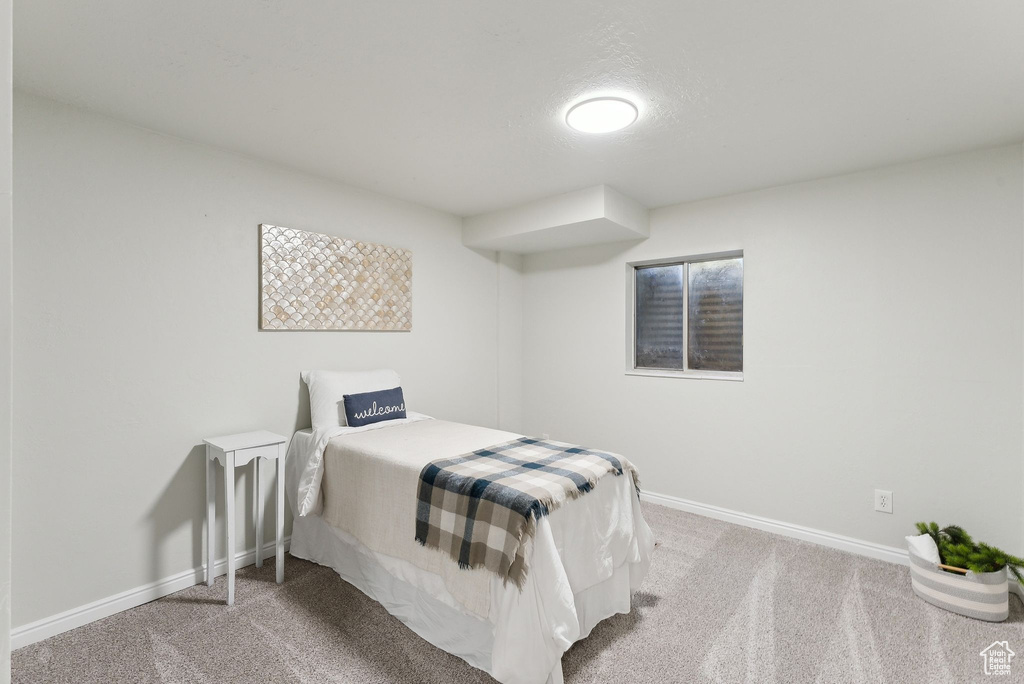 Carpeted bedroom featuring baseboards