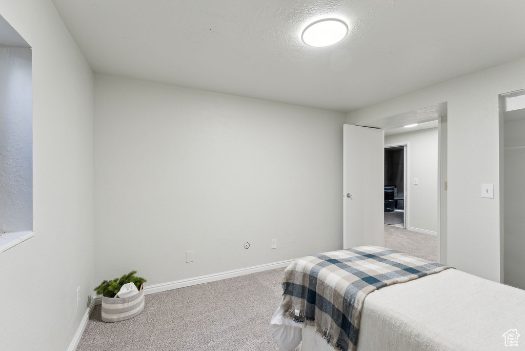 Carpeted bedroom with baseboards