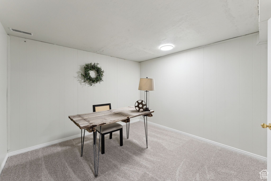Home office with carpet and baseboards