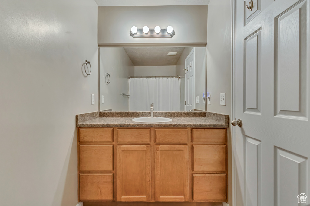 Full bath featuring vanity and a shower with curtain