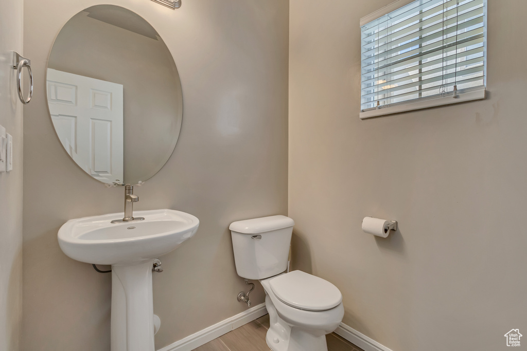 Half bathroom featuring toilet and baseboards