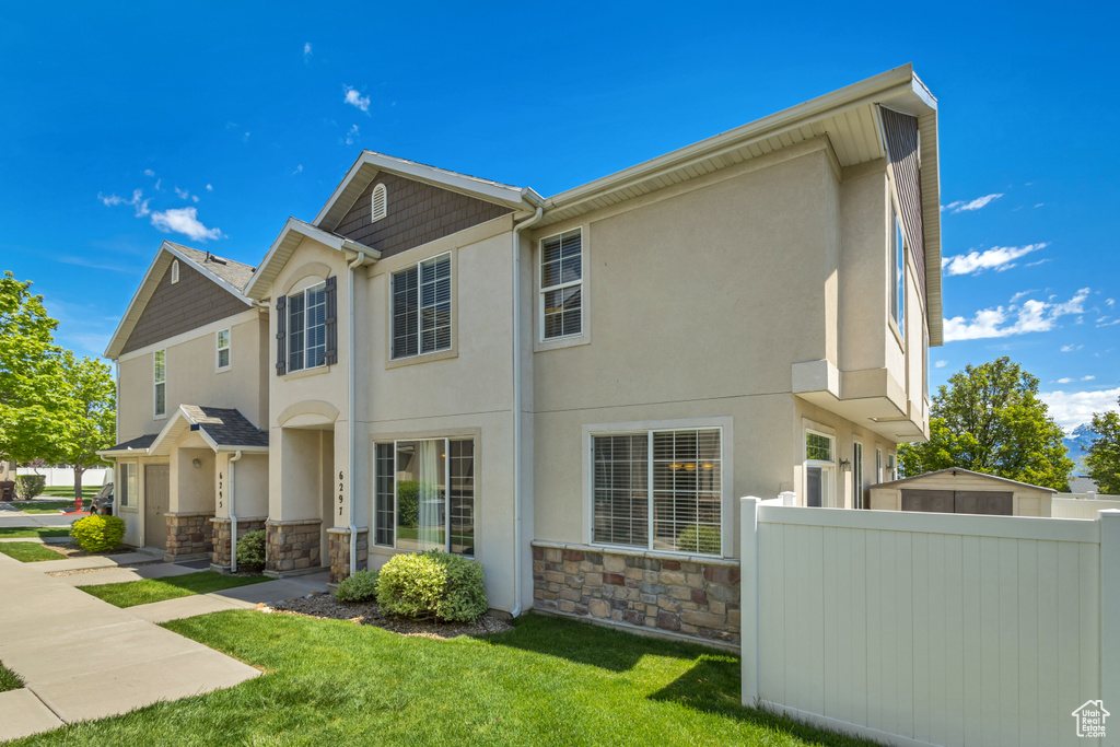 View of home\'s exterior with stone siding and stucco siding