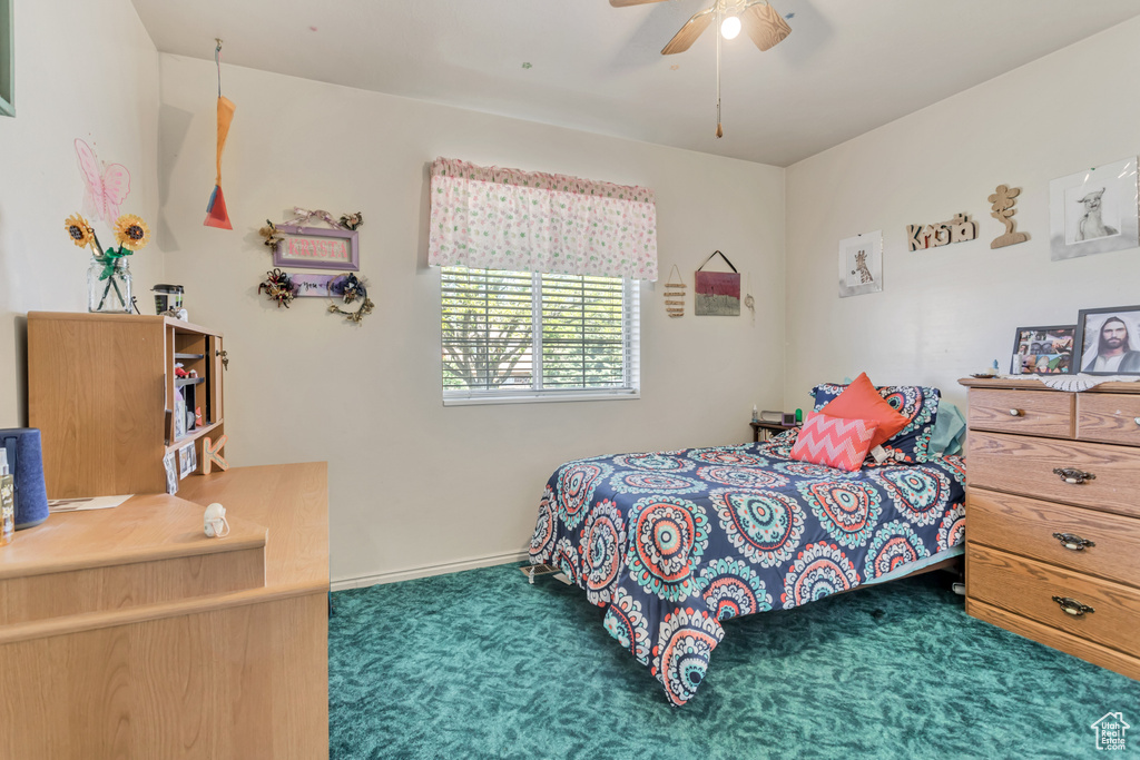 Bedroom with carpet flooring, baseboards, and ceiling fan