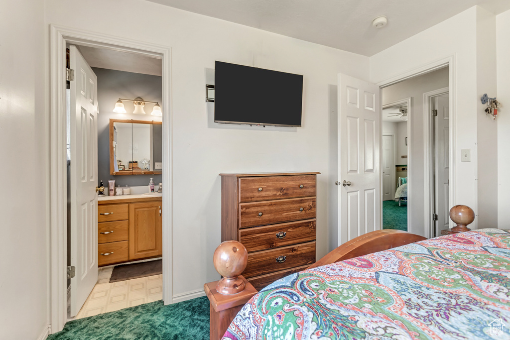 Bedroom featuring ensuite bath and light floors