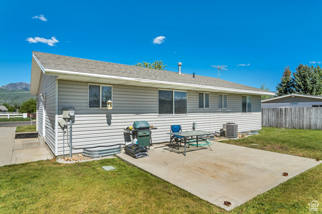 Rear view of house with a patio area and central air condition unit