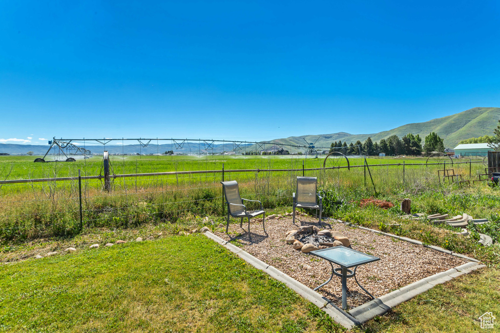 View of yard with a mountain view and a rural view