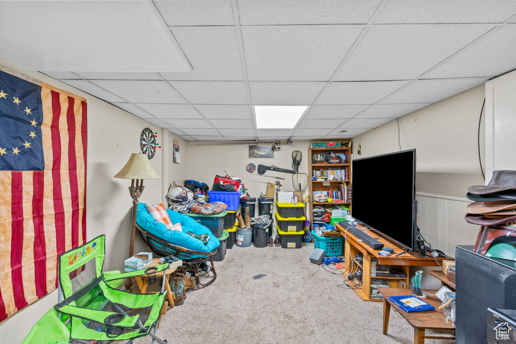 Game room with carpet floors and a paneled ceiling