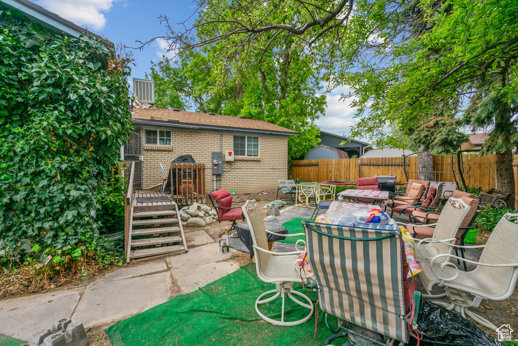 View of patio with a fenced backyard and an outdoor living space