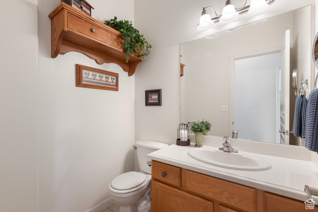 Half bath featuring toilet and vanity