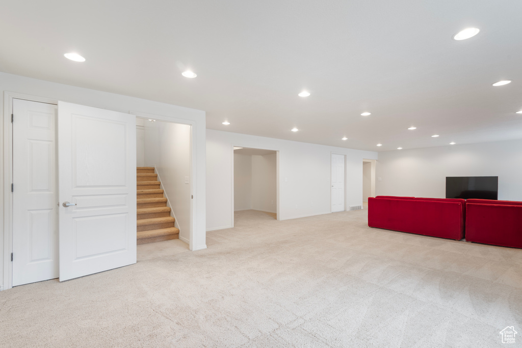 Finished basement featuring carpet, stairway, and recessed lighting