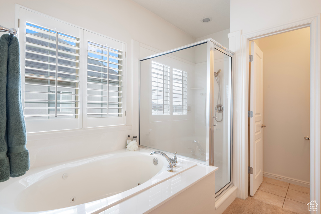 Bathroom with a jetted tub, a stall shower, and tile patterned floors