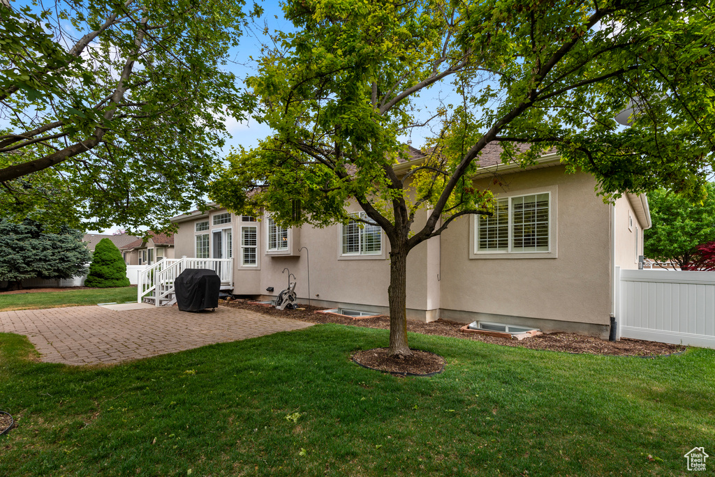 Rear view of house with a patio area and stucco siding