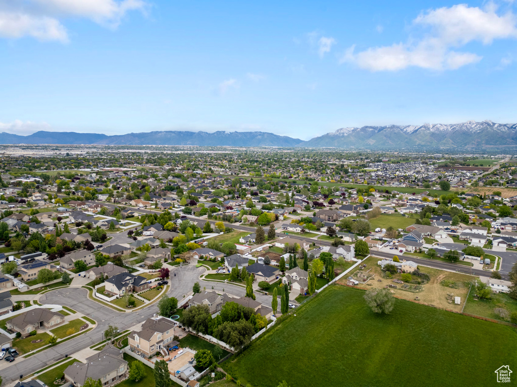 Aerial overview of property\\\'s location with a mountainous background and nearby suburban area