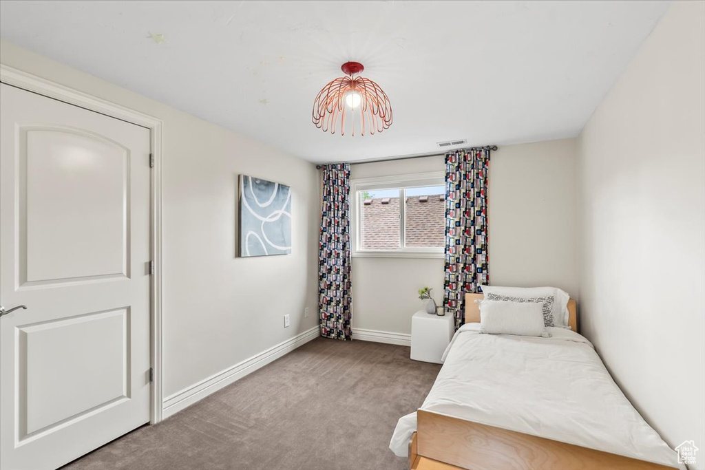 Bedroom with carpet floors and baseboards
