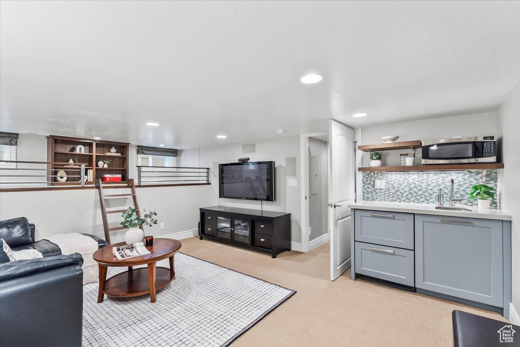Living room featuring light carpet, wet bar, and recessed lighting