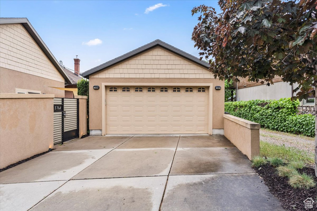 Detached garage featuring a gate