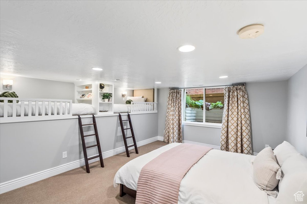 Bedroom with carpet flooring, baseboards, and recessed lighting