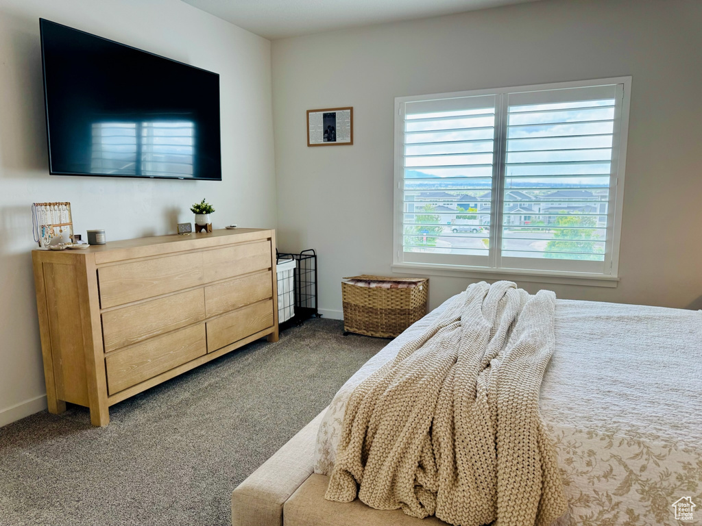 Carpeted bedroom featuring baseboards