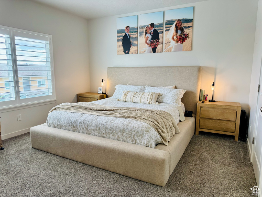 Bedroom featuring carpet flooring and baseboards