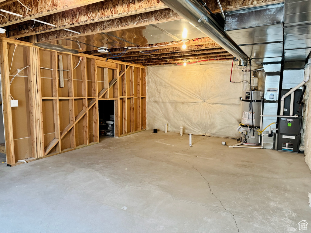 Unfinished below grade area with secured water heater and heating unit
