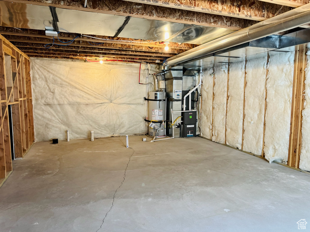 Unfinished below grade area with water heater and heating unit