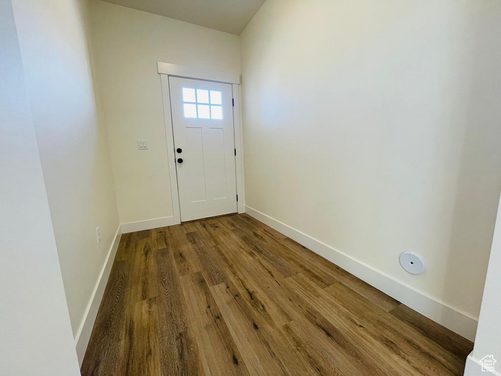 Doorway featuring wood finished floors and baseboards