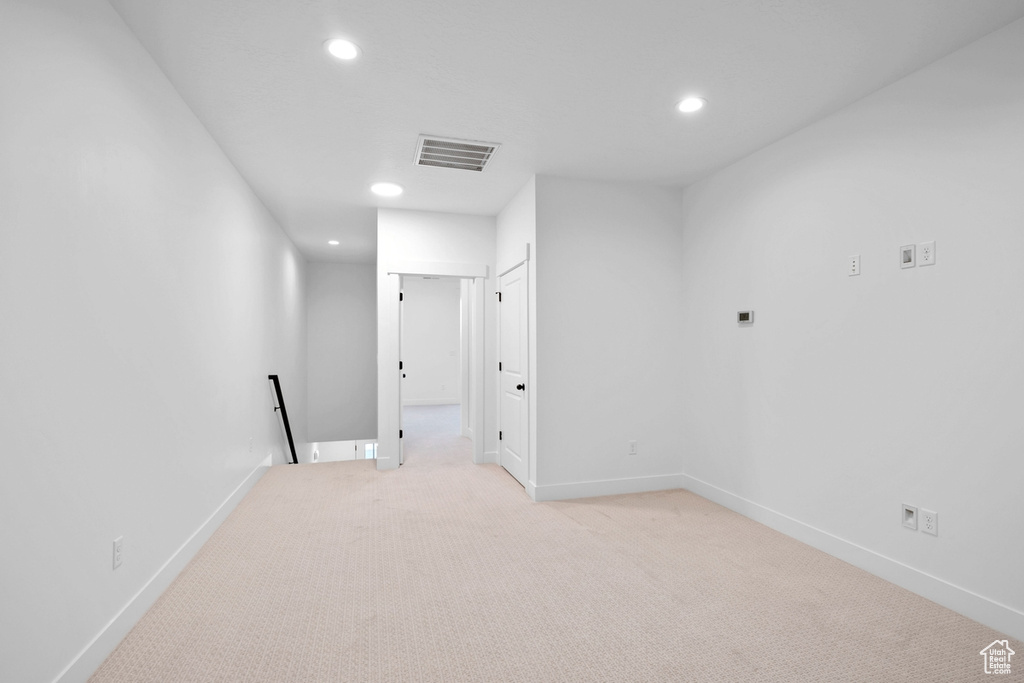 Empty room with recessed lighting, light colored carpet, and baseboards
