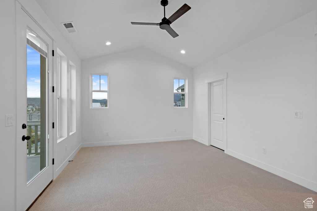 Unfurnished room featuring a ceiling fan, vaulted ceiling, recessed lighting, light carpet, and baseboards