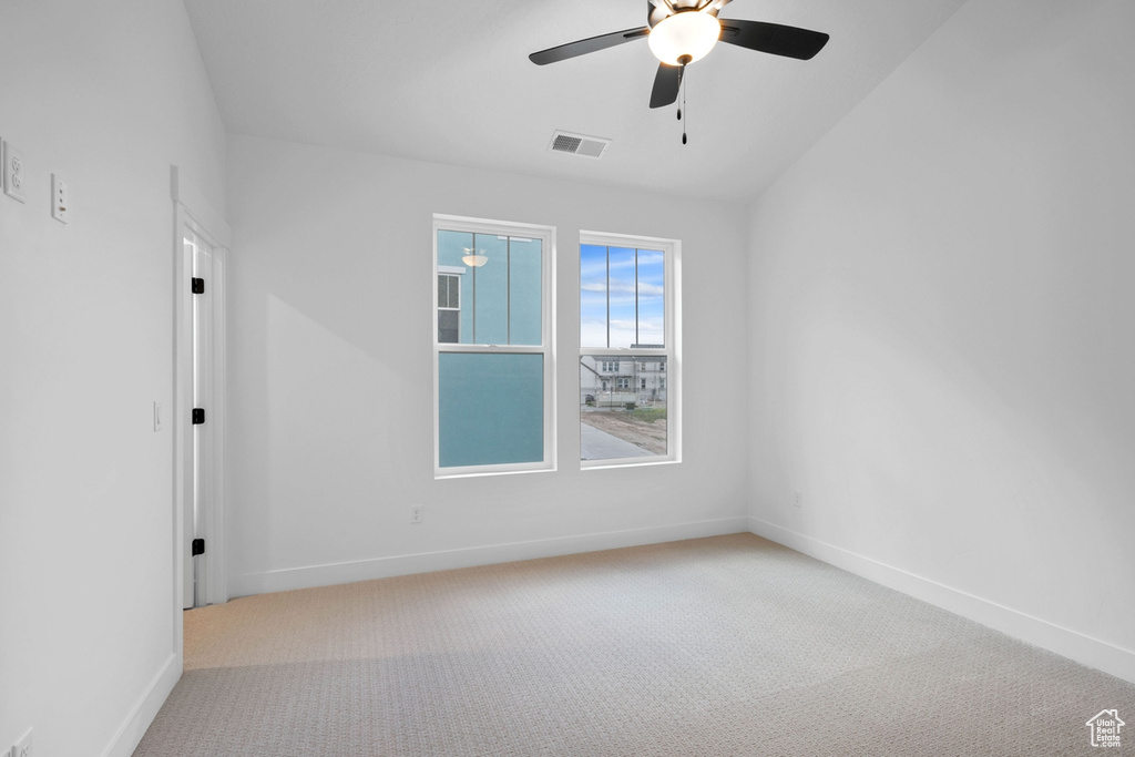 Unfurnished room featuring a ceiling fan, carpet flooring, and baseboards