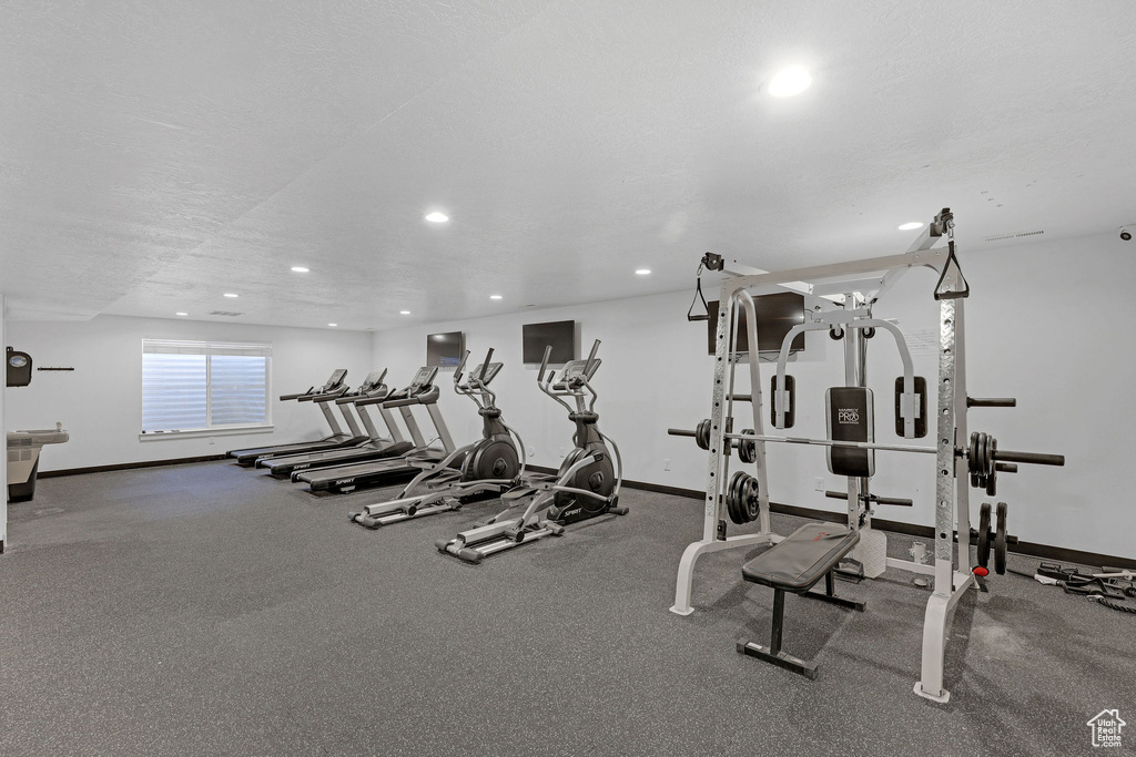 Gym featuring recessed lighting and baseboards