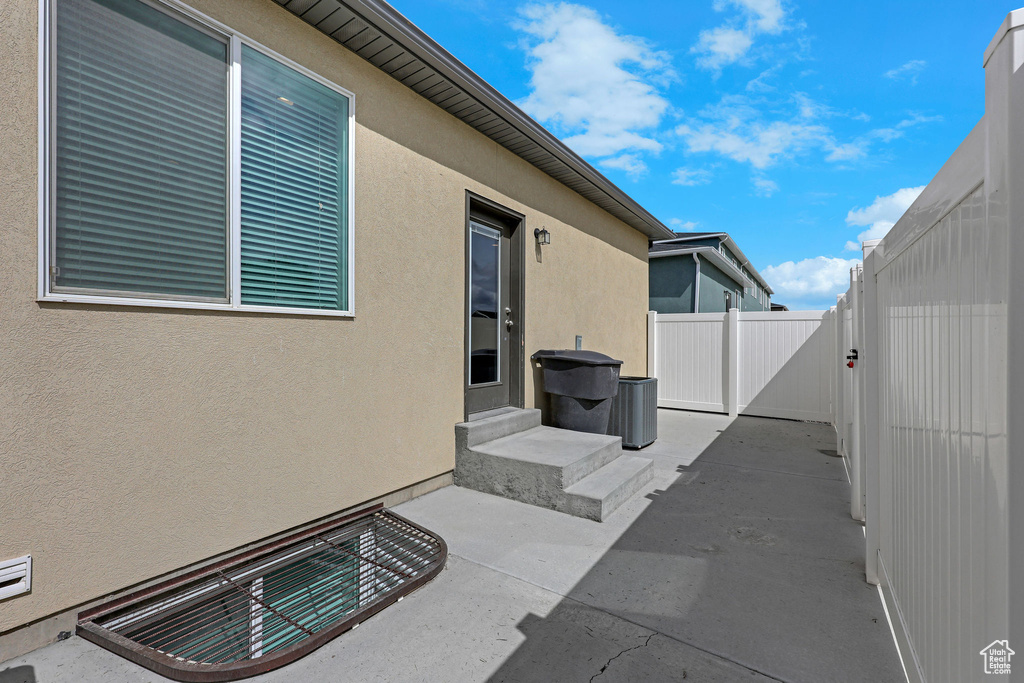 View of patio featuring fence and a gate