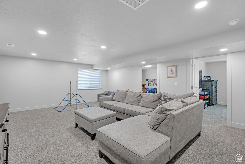 Living area featuring recessed lighting, light colored carpet, and baseboards