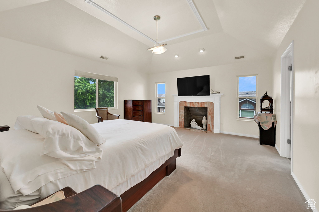 Bedroom featuring light carpet, a tiled fireplace, recessed lighting, and baseboards