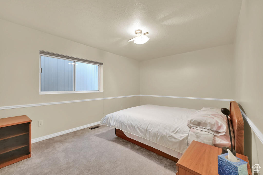 Carpeted bedroom featuring baseboards