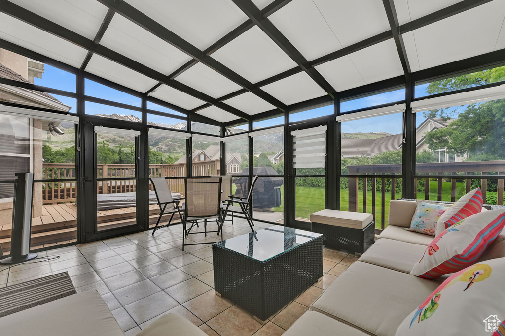 Sunroom / solarium featuring an outdoor living space and lofted ceiling