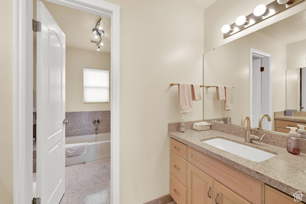 Bathroom featuring vanity and a garden tub