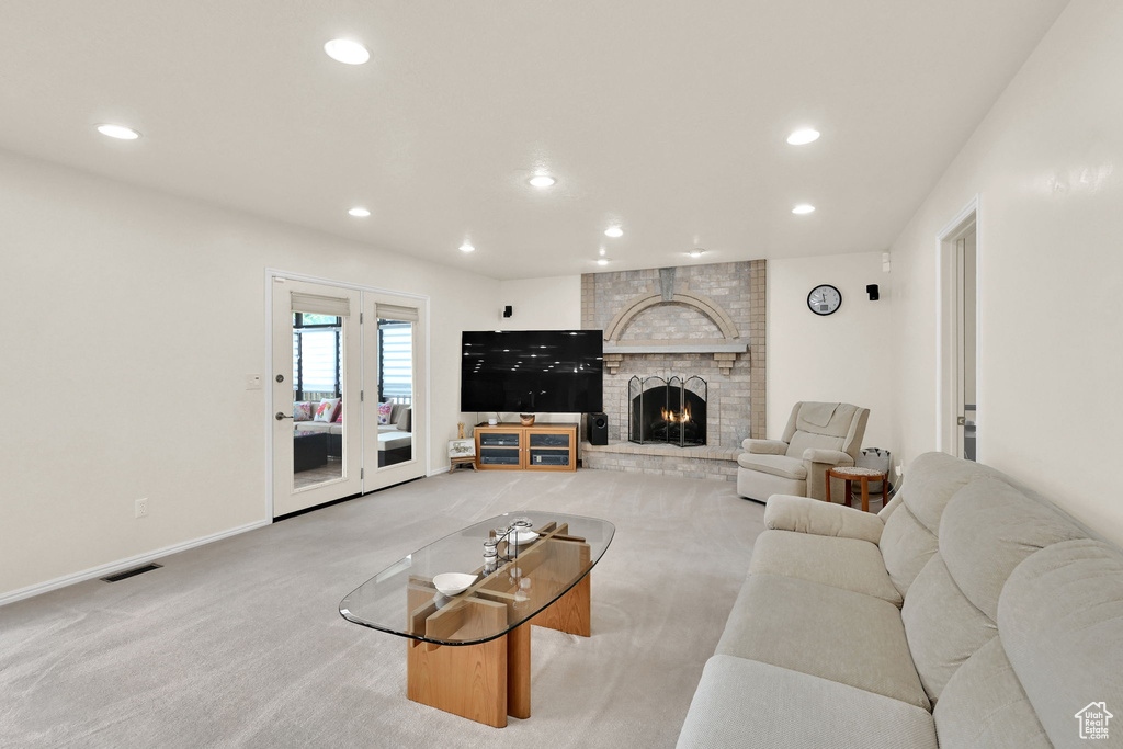 Living room featuring recessed lighting, carpet flooring, baseboards, and a brick fireplace