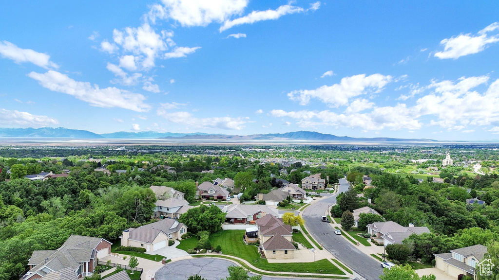 Aerial perspective of suburban area featuring a mountainous background