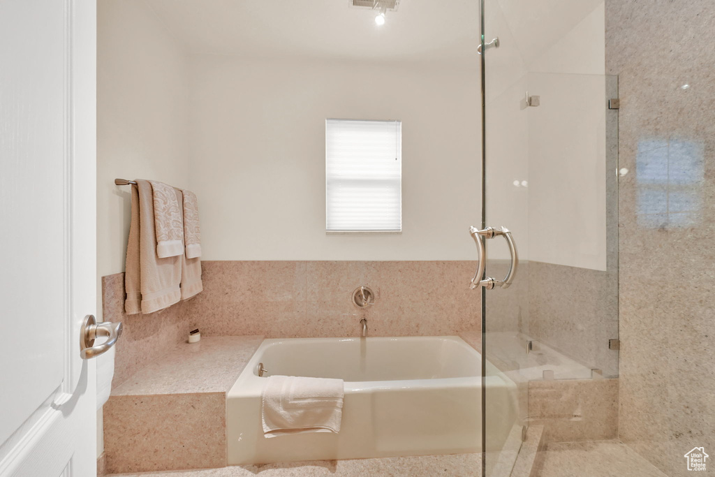 Bathroom with a bath and a shower with shower door