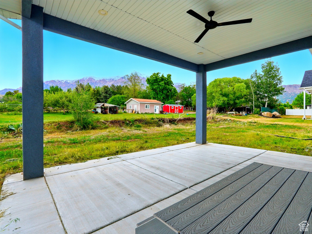 View of patio featuring a ceiling fan and a mountain view