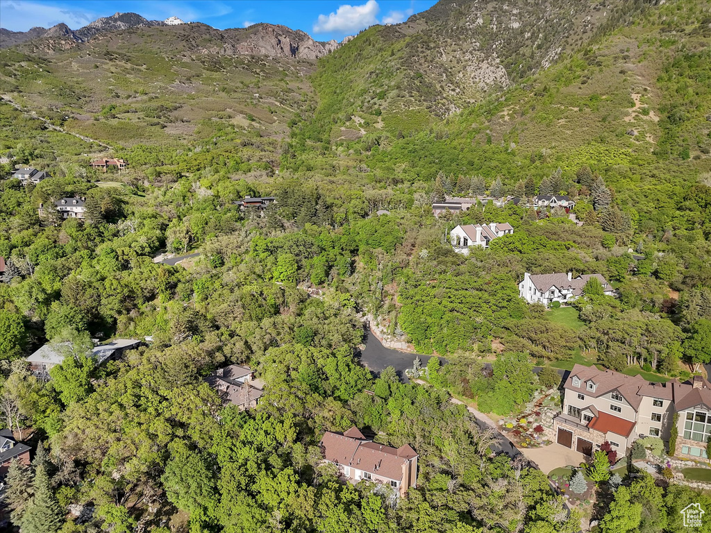 Aerial overview of property\\\\\\\\\\\\\\\\\\\\\\\\\\\\\\\'s location featuring a forest and a mountain backdrop